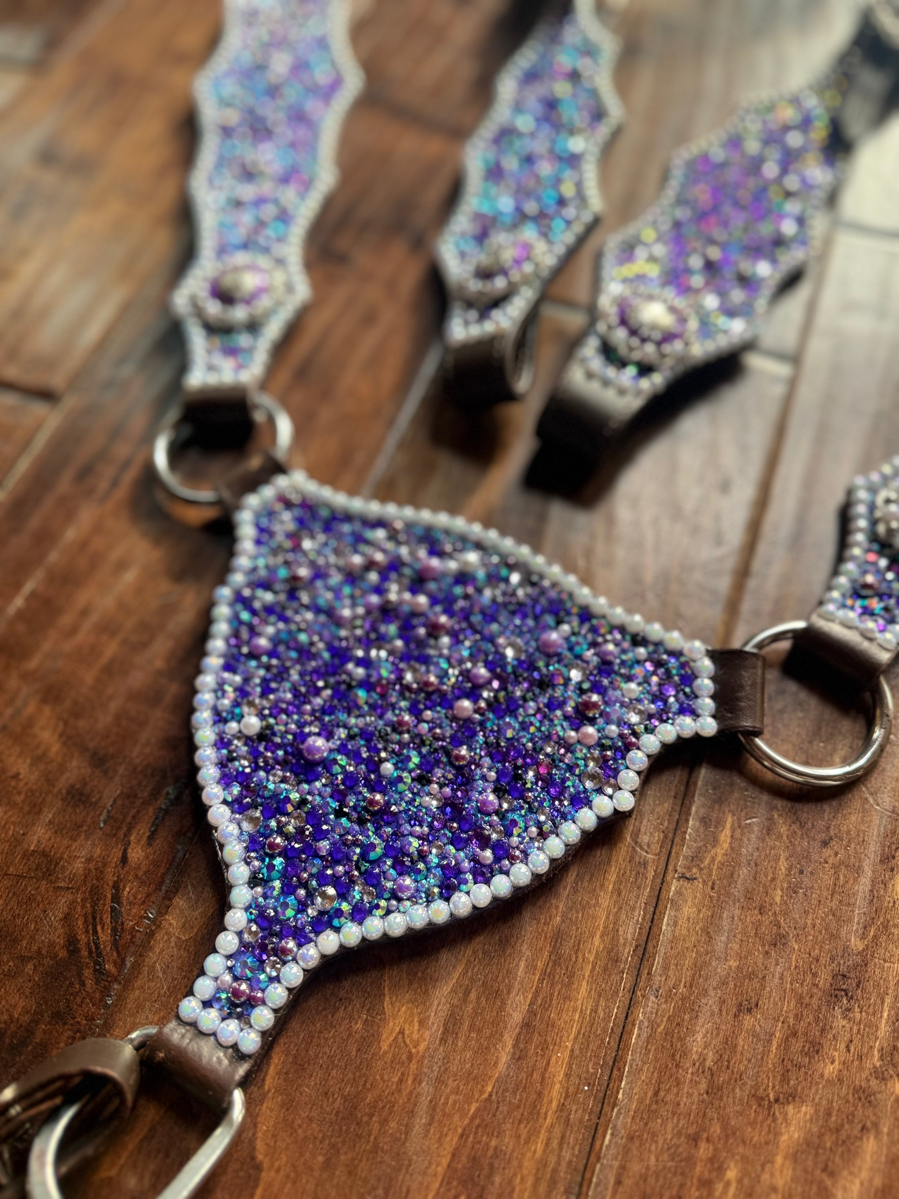 Decorative equestrian bridle with beaded cover on a wooden surface