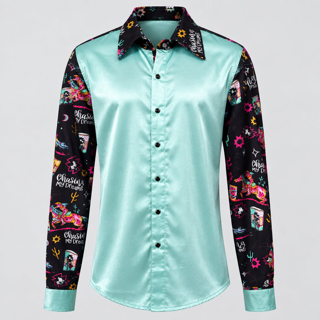 A long-sleeve satin button-up shirt displayed on a mannequin torso indoors. The shirt has a light aqua/mint body with black patterned sleeves and collar featuring small colorful graphic prints.